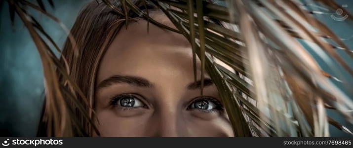 Portrait of a Beautiful Young Woman On Tropical Island In Vacation. Closeup Photo Of a Woman&rsquo;s Eyes Looking through Palm Leaves. Enjoying Exotic Nature.