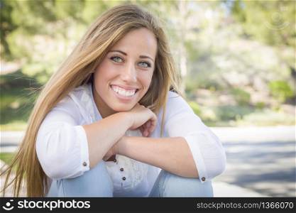 Portrait of a Beautiful Young Woman Outdoors at the Park.