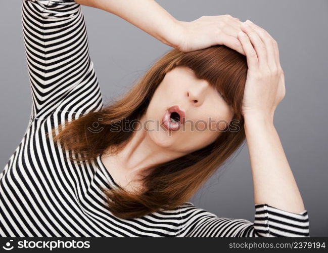 Portrait of a beautiful young woman over a gray background