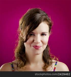 Portrait of a beautiful young woman over a pink background 