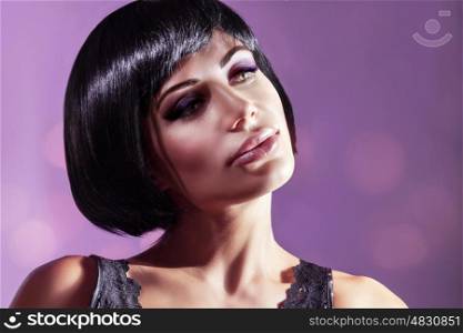 Portrait of a beautiful young woman over purple background, attractive model with gorgeous bob haircut and bright makeup, luxury fashion look