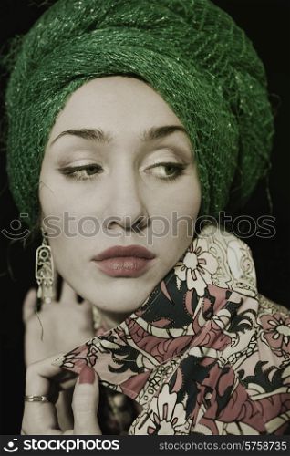 portrait of a beautiful young woman wearing a woman&rsquo;s headdress