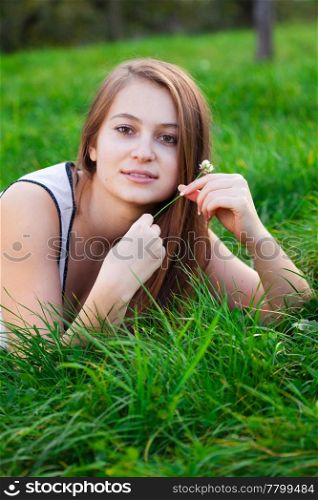 portrait of a beautiful young woman with flower outdoor