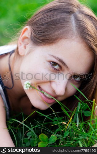 portrait of a beautiful young woman with flower outdoor