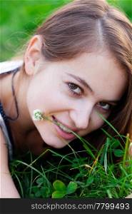 portrait of a beautiful young woman with flower outdoor
