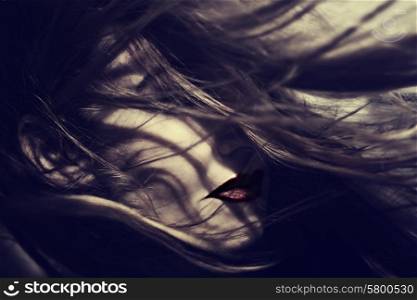 Portrait of a beautiful young woman with hair fluttering on the wind