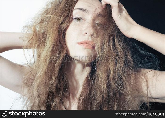 Portrait of a beautiful young woman with long curly hair