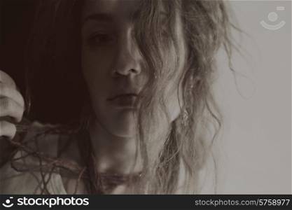 Portrait of a beautiful young woman with long curly hair