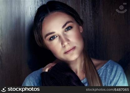 Portrait of a beautiful young woman with natural makeup over wooden background, calm and peaceful female, genuine women&rsquo;s beauty concept. Genuine women&rsquo;s beauty
