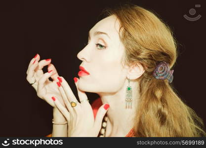 Portrait of a beautiful young woman with red manicure closeup