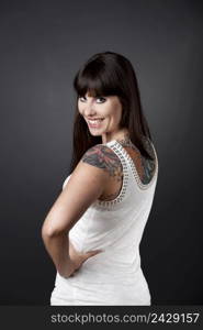 Portrait of a beautiful young woman with tattoos smiling