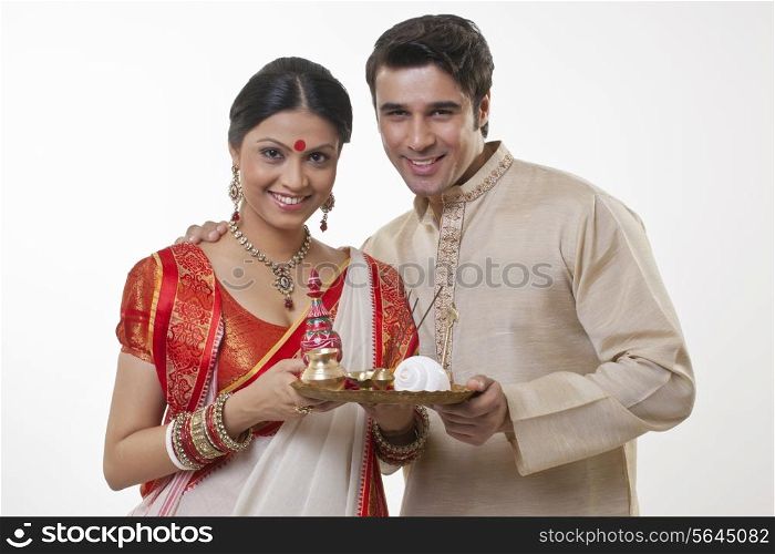 Portrait of a Bengali couple with a puja thali