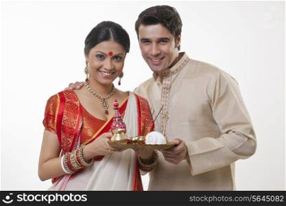 Portrait of a Bengali couple with a puja thali