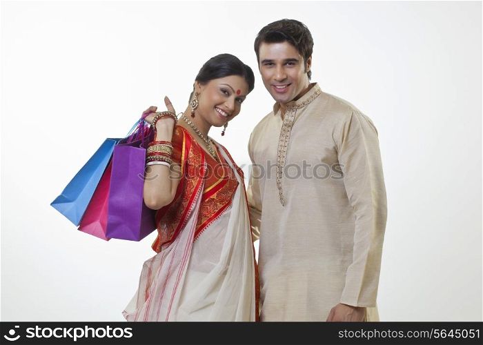 Portrait of a Bengali couple with shopping bags
