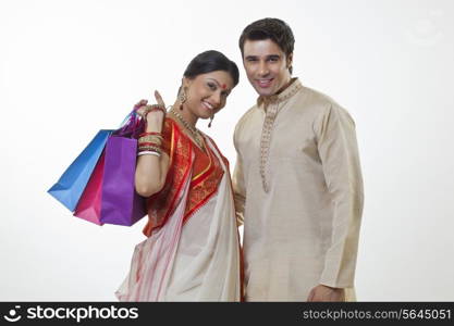 Portrait of a Bengali couple with shopping bags