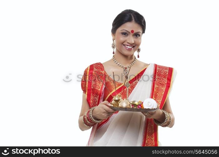 Portrait of a Bengali woman holding a puja thali
