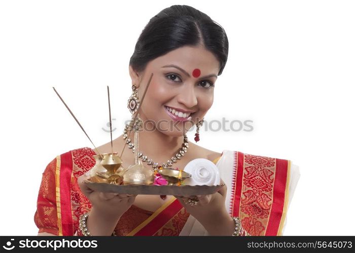 Portrait of a Bengali woman holding a puja thali