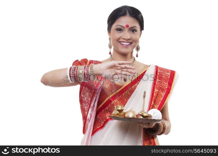 Portrait of a Bengali woman holding a puja thali