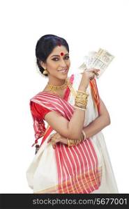 Portrait of a Bengali woman holding currency notes