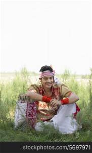 Portrait of a Bihu dancer sitting with a dhol