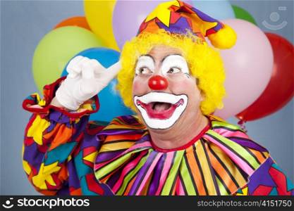 Portrait of a birthday clown with a bright idea.