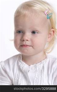 Portrait Of A Blond Toddler Girl With A Timid Expression