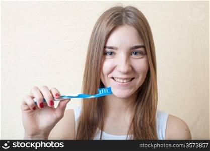 Portrait Of A Blond Woman Brushing Her Teeth