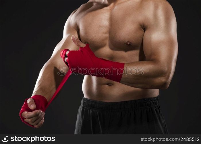 Portrait of a body combat athlet aplying tape on the hands