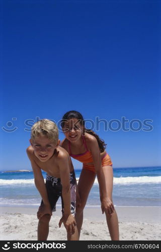 Portrait of a boy and a girl standing on the beach