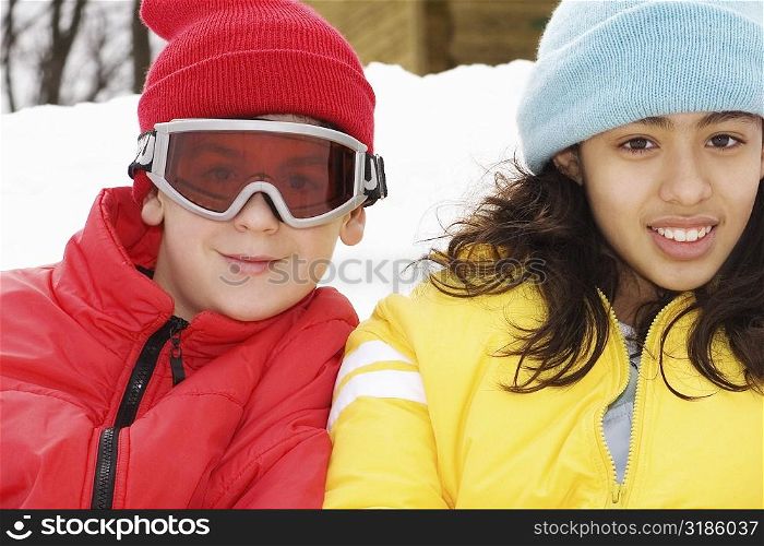 Portrait of a boy and a teenage girl smiling