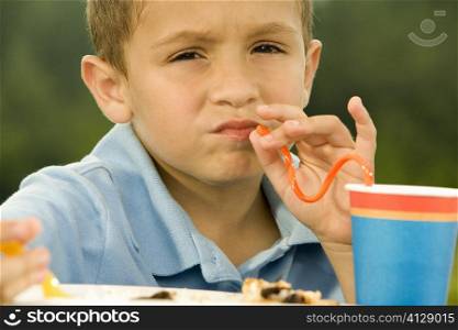 Portrait of a boy drinking through straw