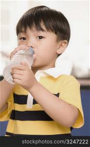 Portrait of a boy drinking water from a bottle