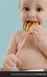 Portrait of a boy eating a lollipop