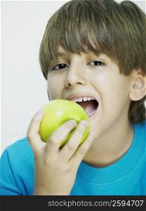 Portrait of a boy eating an apple