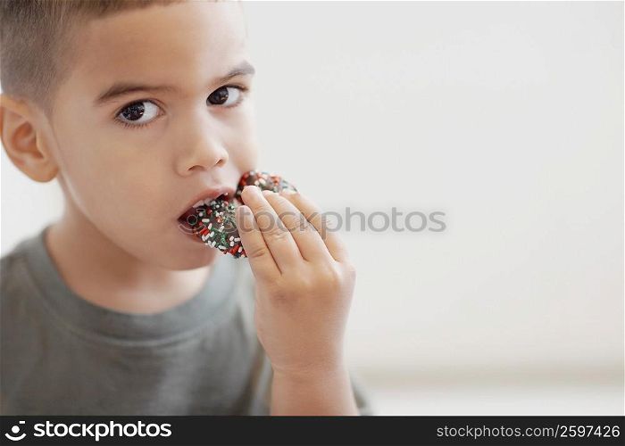 Portrait of a boy eating candy