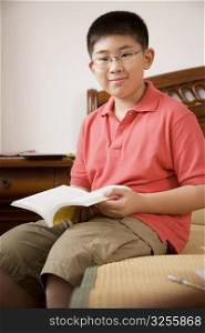 Portrait of a boy holding a book