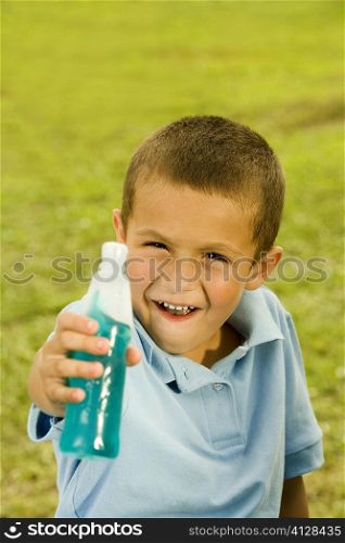 Portrait of a boy holding a bottle
