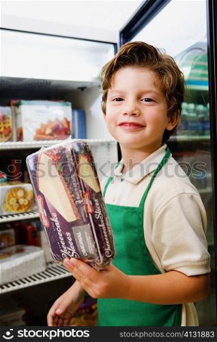 Portrait of a boy holding a box of cake and smiling