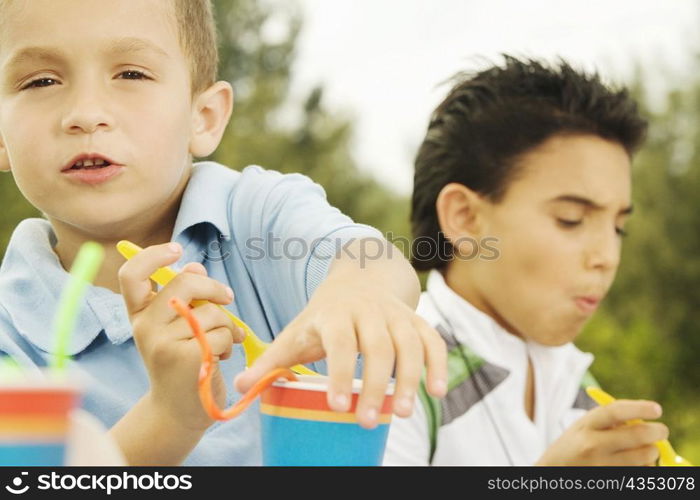 Portrait of a boy holding a disposable cup