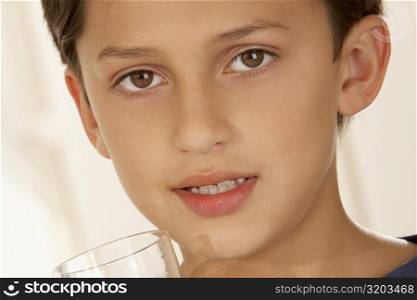 Portrait of a boy holding a glass