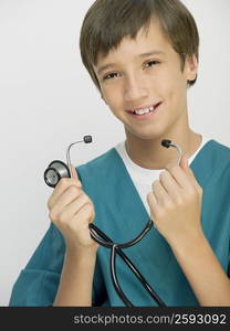 Portrait of a boy holding a stethoscope