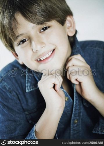 Portrait of a boy holding his shirt collar