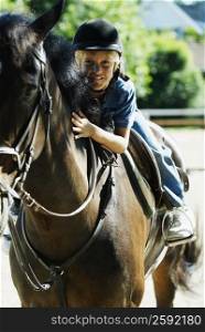 Portrait of a boy horseback riding