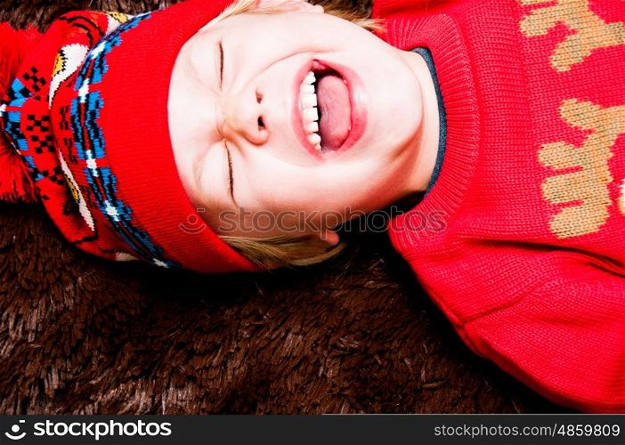 Portrait of a boy laughing in winter attire