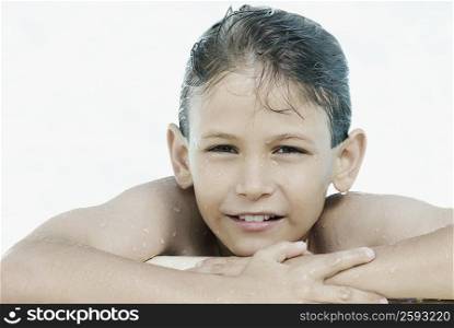 Portrait of a boy leaning at the poolside
