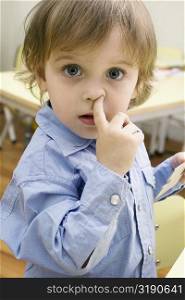 Portrait of a boy picking nose