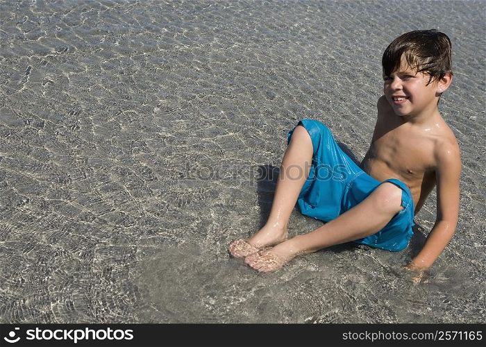 Portrait of a boy playing in water on the beach