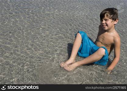 Portrait of a boy playing in water on the beach