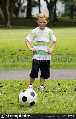 Portrait of a boy playing soccer in a park