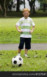 Portrait of a boy playing soccer in a park